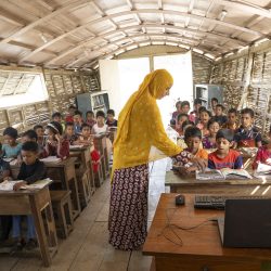 A female teacher conducts a class for the students of grade one at a boat school at Chatmohor, Pabna. Photo: Abir Abdullah/Shidhulai Swanirvar Sangstha
