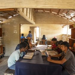 Both male and female students read books  at the boat library run by Shidhulai Swanirvar Sangstha, at Borda Nagar Uttor Para, Chatmohor, Pabna. Photo: Abir Abdullah/Shidhulai Swanirvar Sangstha