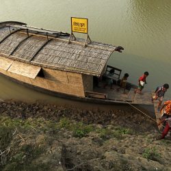 Students return home after the end of the classes for the day. The floating boat school moves from one area to another and goes to the children for giving education as the children don't go to the traditional school because of lack of communication during flooding, Billdohor, Natore.