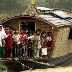 Students of class one on the boat school, pose for a photograph, after the end of their classes. The floating boat school moves from one area to another and goes to the children for giving education as the children don't go to the traditional school because of lack of communication during flooding, Billdohor, Natore.Billdohor, Natore.